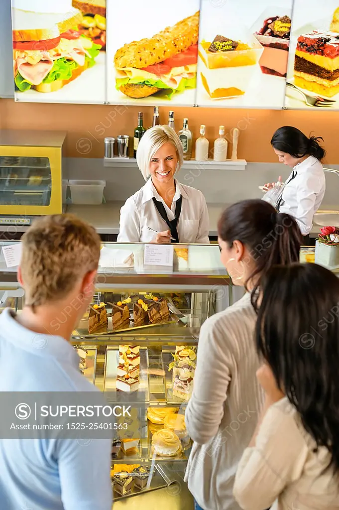 Customers waiting in line to buy dessert woman man cafe