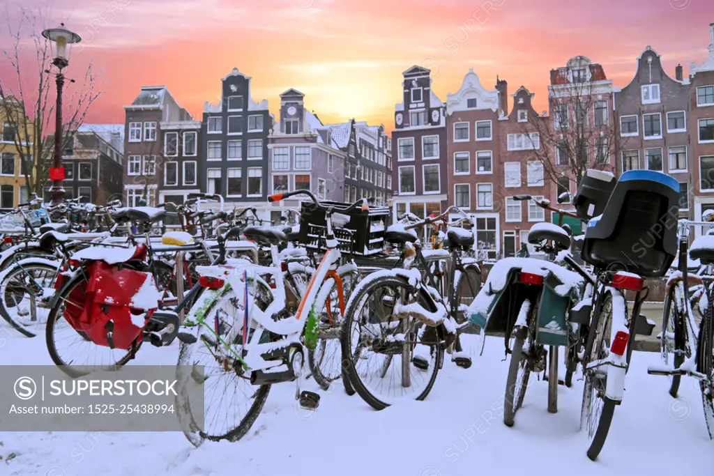 Snowy bikes in Amsterdam the Netherlands at sunset