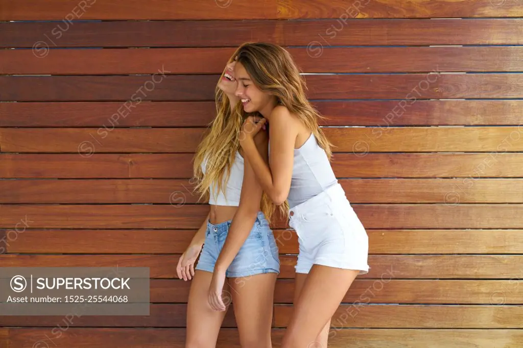 Best friends teen girls happy having fun together hug