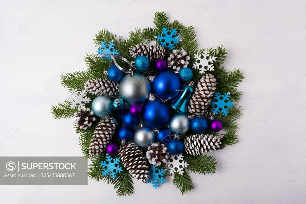 Christmas wreath with blue color shades ornaments. Christmas decoration with blue balls, fir branches and pine cones. Christmas greeting background. 