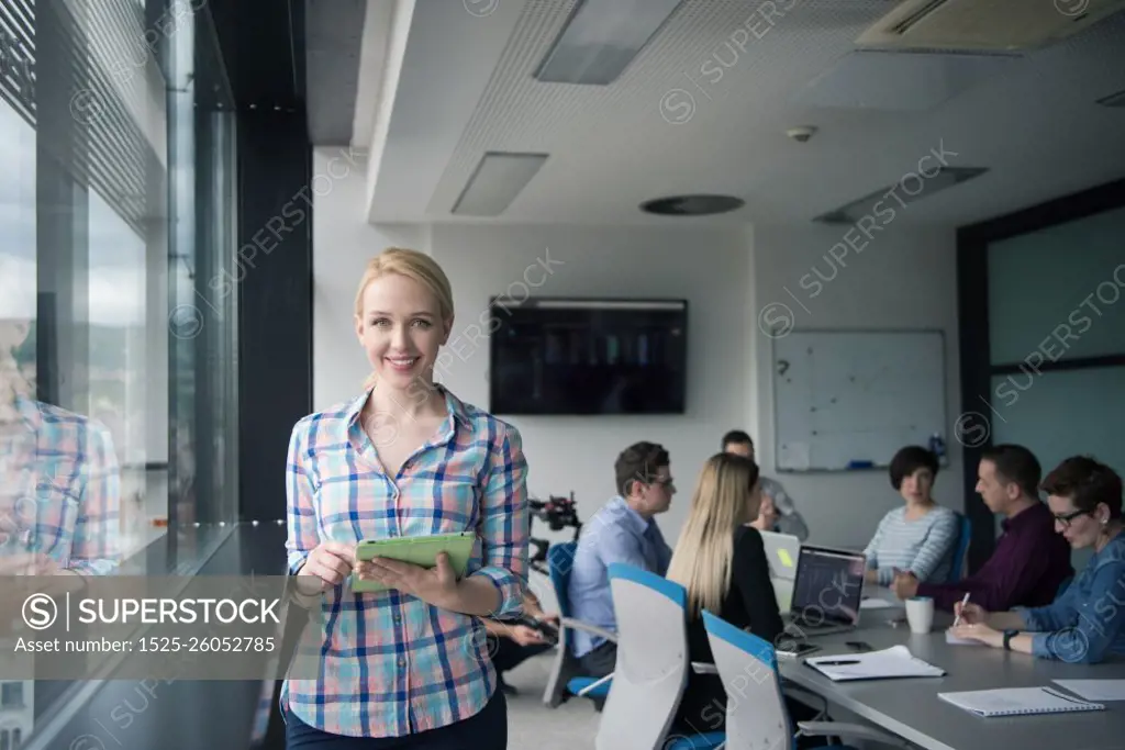 Business Woman Using Digital Tablet in corporate office by window