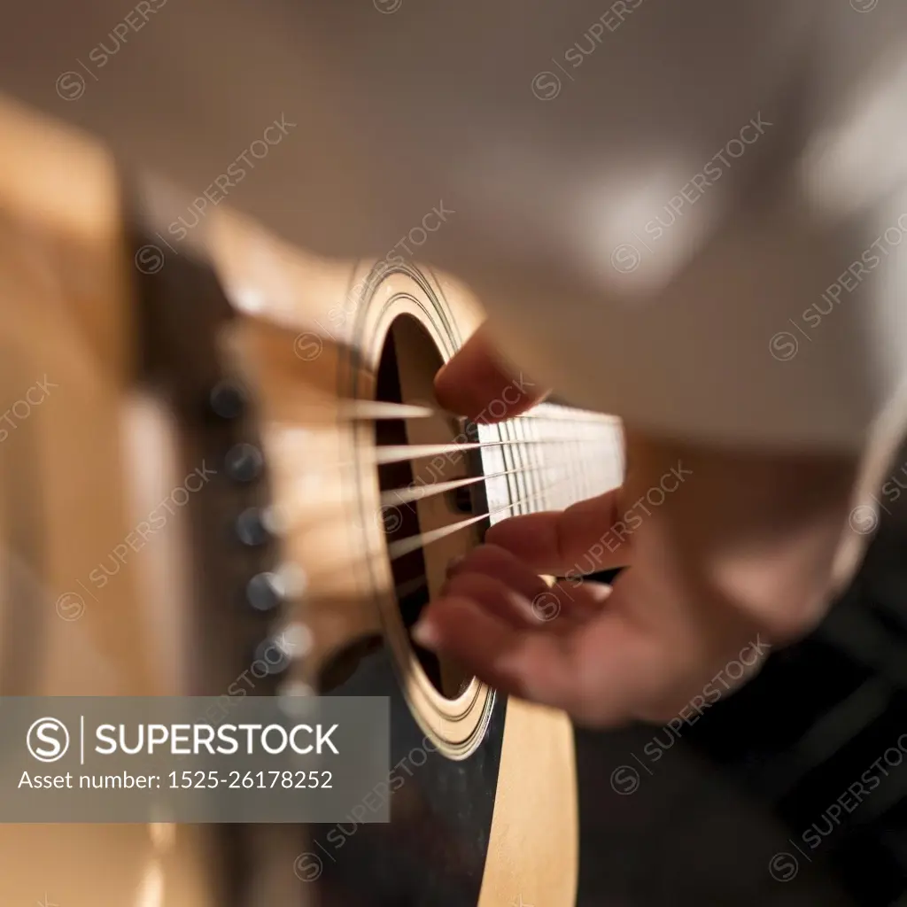 extreme close up man person playing guitar