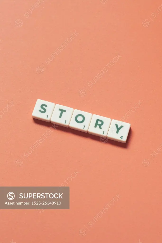 Story word formed of scrabble tiles on orange background. Creative web design in pastel color.. Story formed of scrabble tiles on orange background.