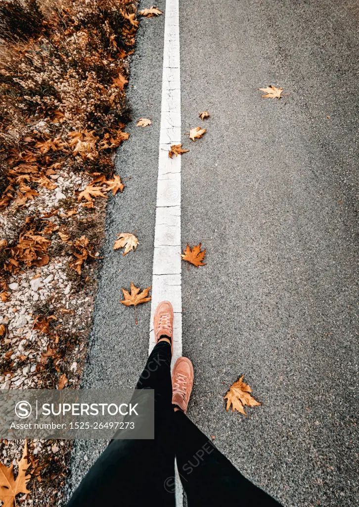 Woman Walking Along the Road in the Autumn. Spending Calm Fall Day Alone with Myself. Season Changes Concept.. Walking to New Season