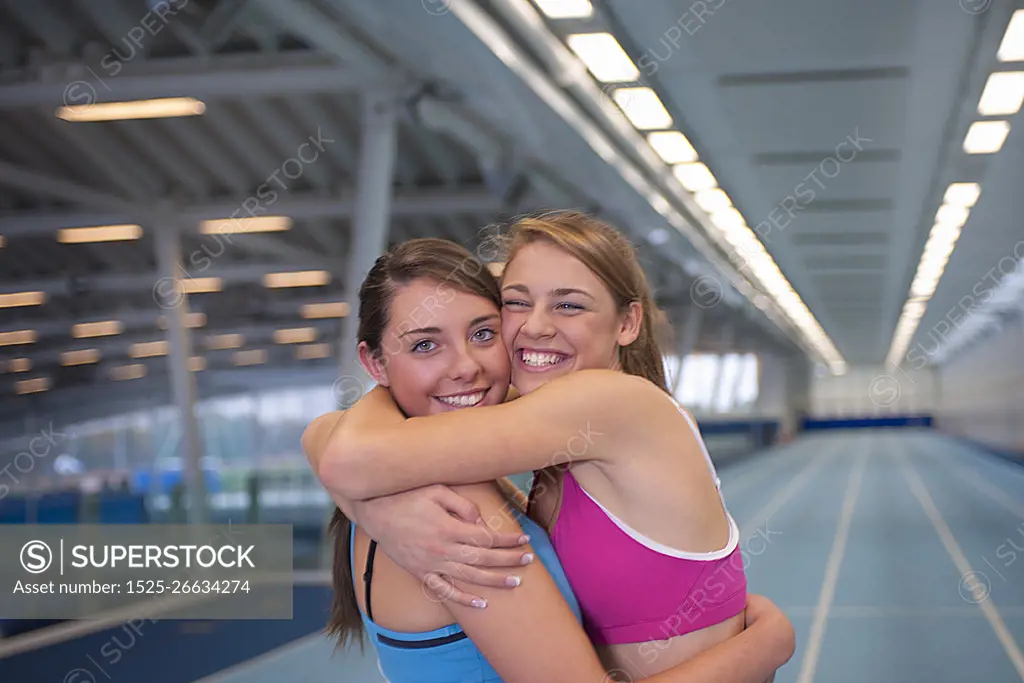 2 female athletes embracing