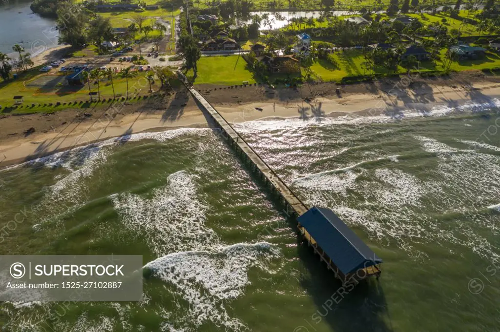 Aerial panoramic image at sunrise off the coast over Hanalei Bay and pier on Hawaiian island of Kauai. Aerial drone shot of Hanalei bay and beach on the north shore of Kauai in Hawaii