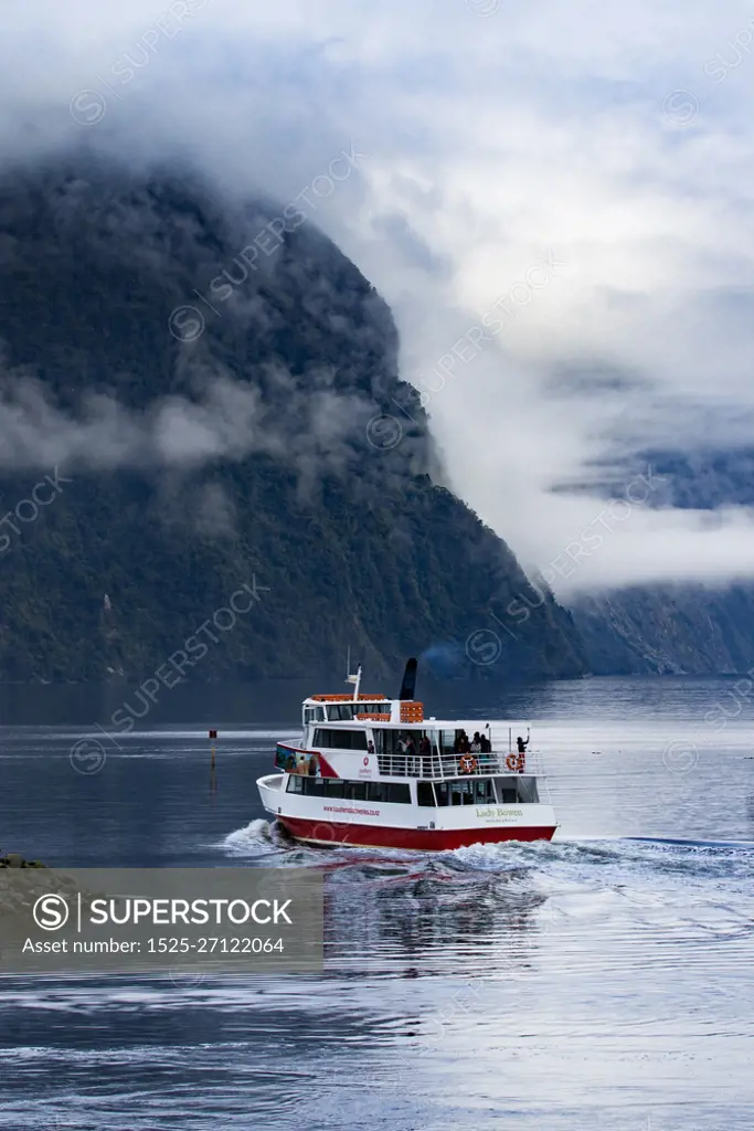 MILFORD SOUND NEW ZEALAND - AUGUST 30,2015 : tourist boat cruising in harbor of milford sound most popular natural traveling destination in southland new zealand