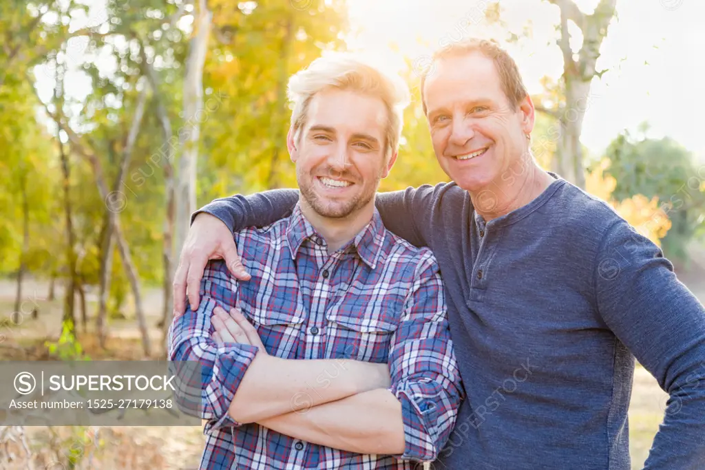 Happy Caucasian Father and Son Portrait Outdoors.