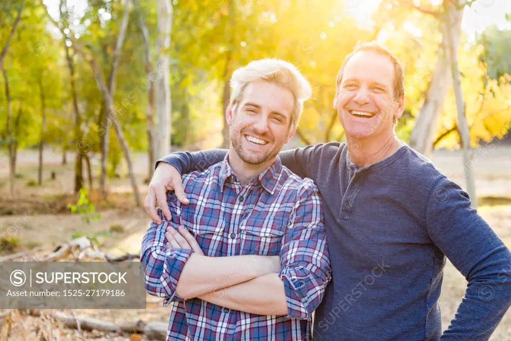 Happy Caucasian Father and Son Portrait Outdoors.