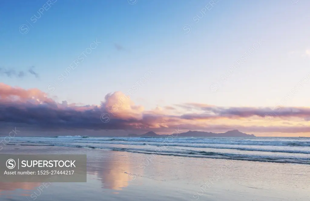 Beautiful Sunset at the Ocean Beach, New Zealand. Inspiring natural and travel background