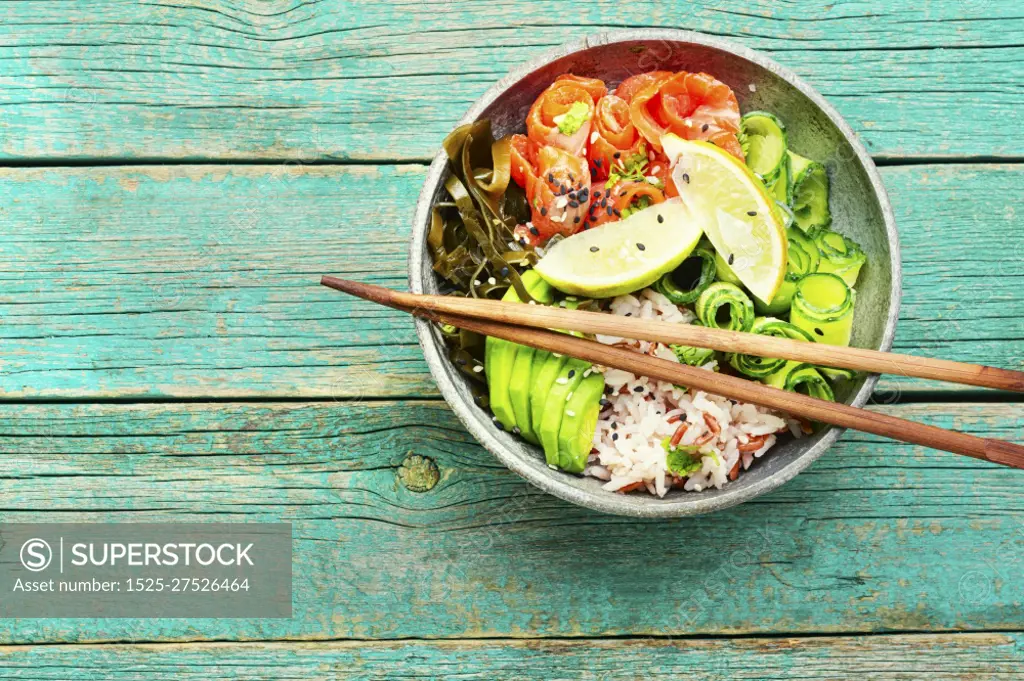 Hawaiian salmon poke bowl with rice,seaweed and avocado. Hawaiian poke bowl