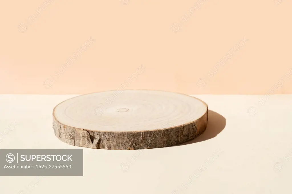 Minimal modern product display on textured beige background with wooden podium. Minimal product display