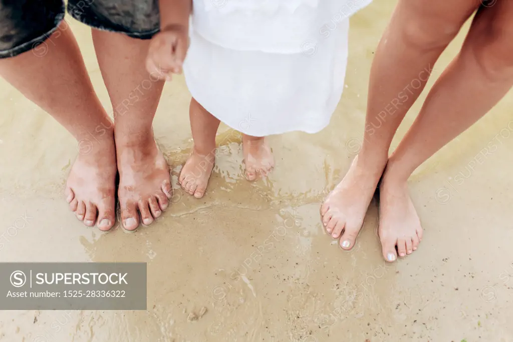 legs dad, mom, daughters. The family legs with little daughter on the beach. The family legs with little daughter on the beach. legs dad, mom, daughters