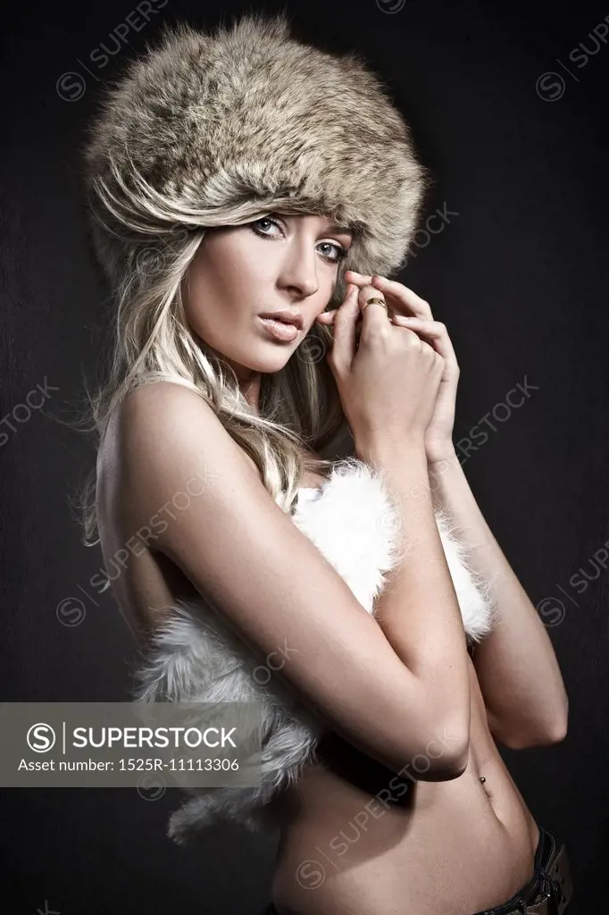 Stunning blonde beauty over dark studio background