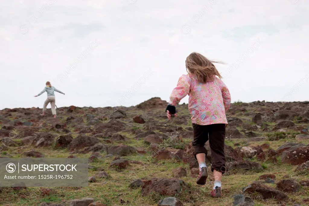 Girl running in field in Kenya