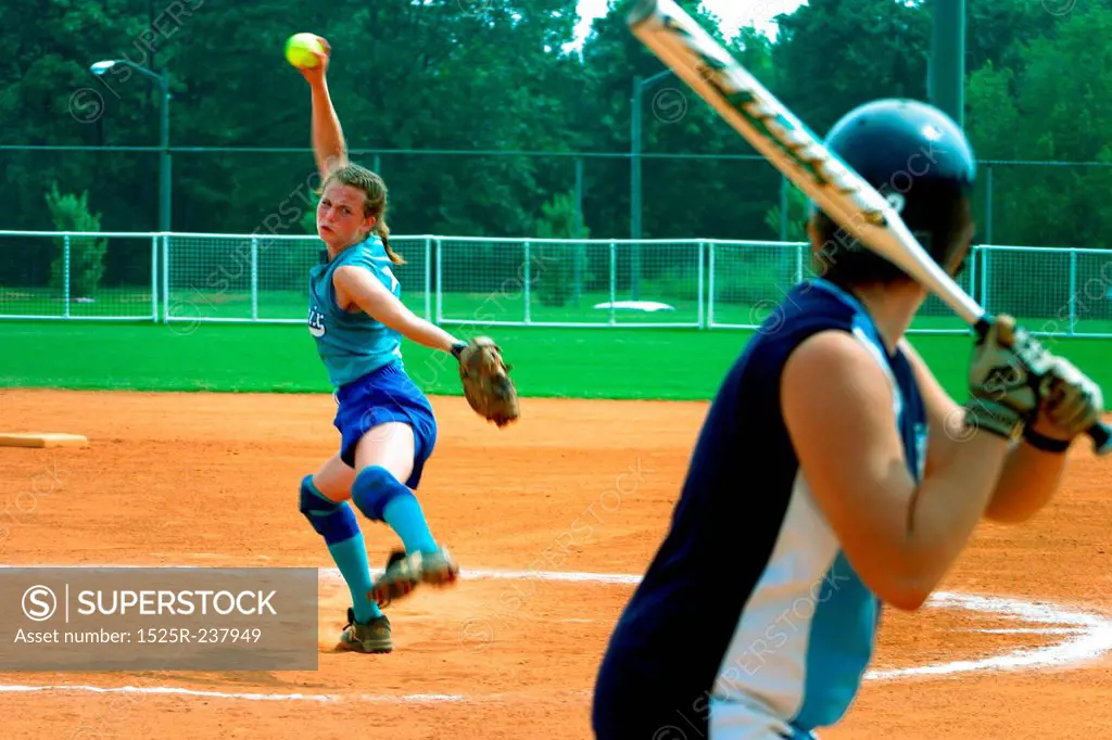 Female Softball Player Pitching To A Batter