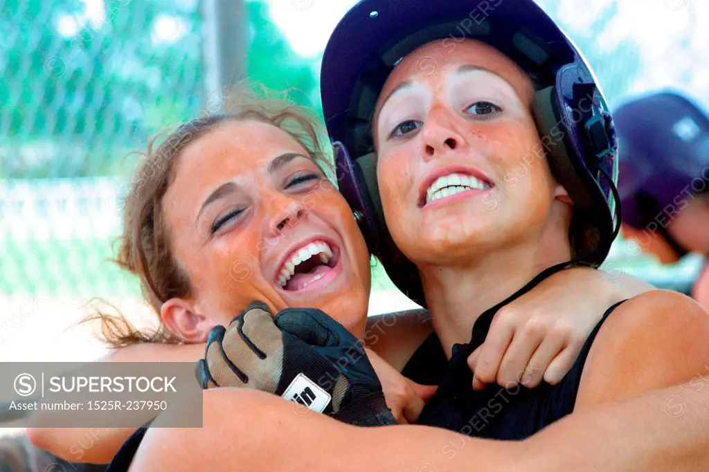 Softball Teammates Hugging Each Other And Laughing