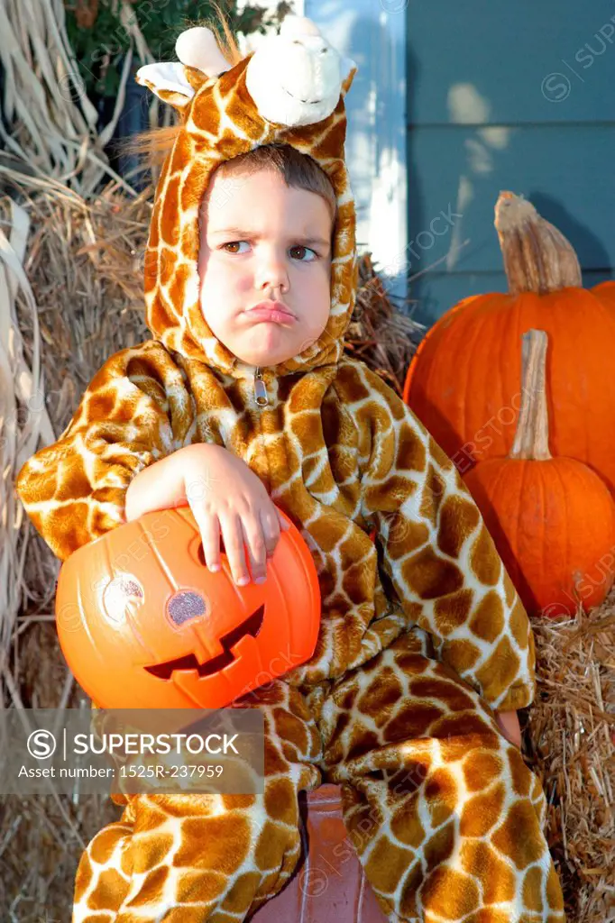 Caucasian Boy Wearing A Giraffe Costume And Frowning On Halloween