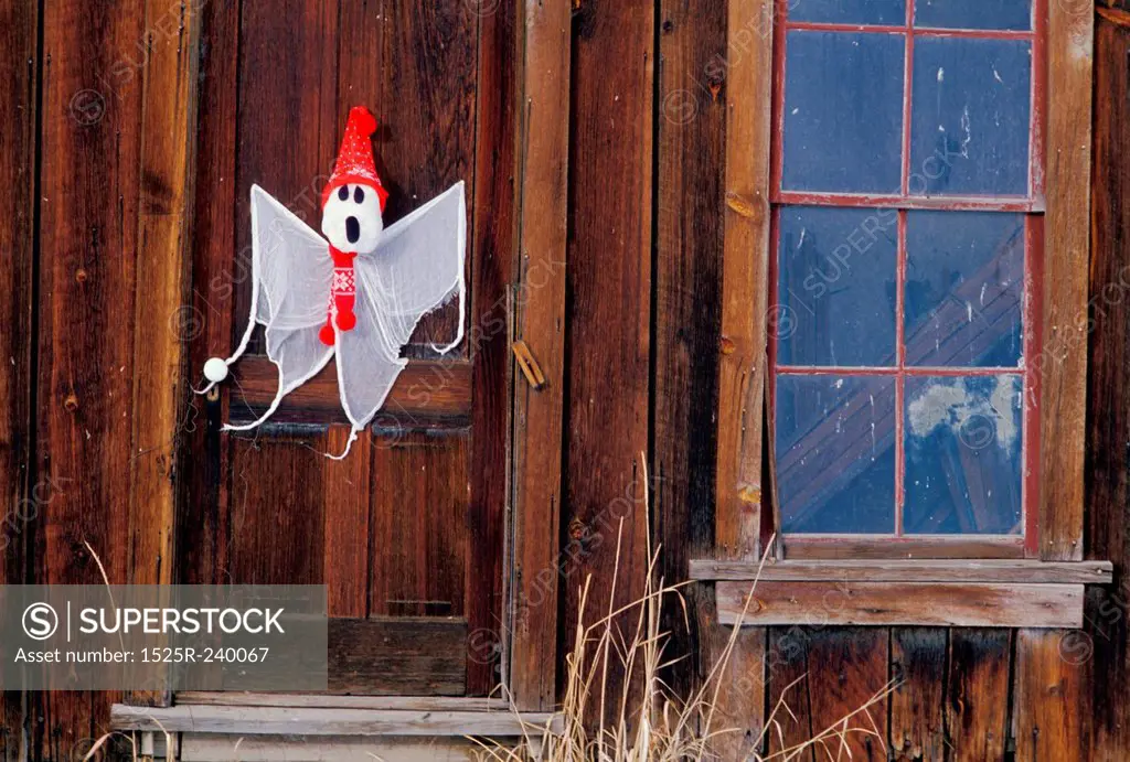 Halloween ghost decoration on wooden door of old-fashioned house