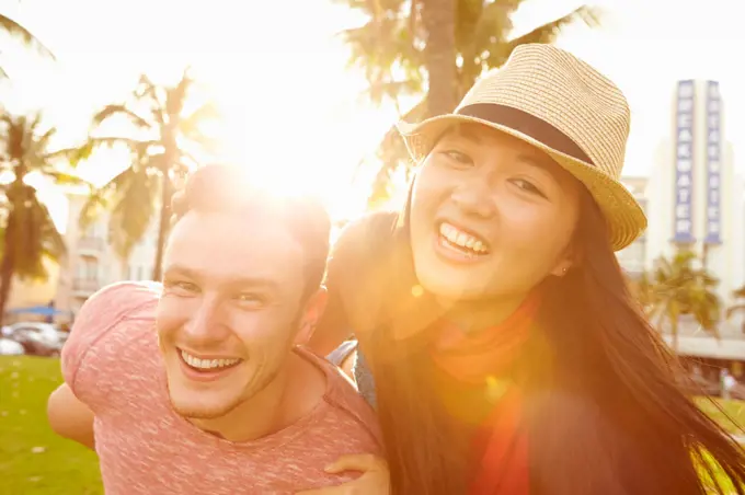 Young Couple Having Fun In Park Together