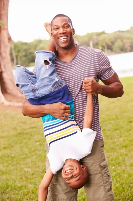 Father And Son Having Fun In Garden Together