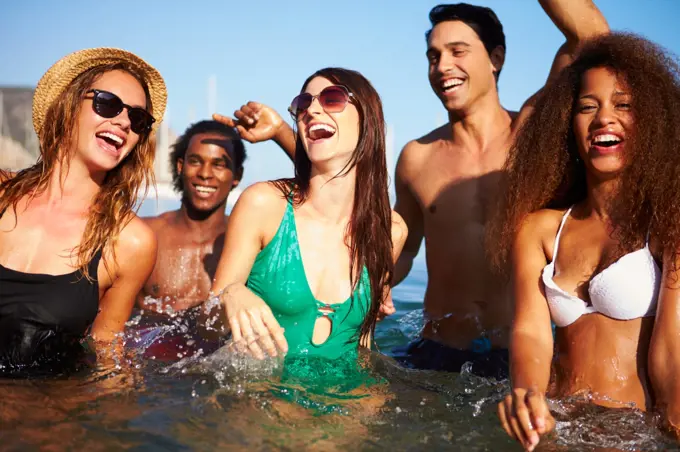 Group Of Young Friends Having Fun In Sea Together