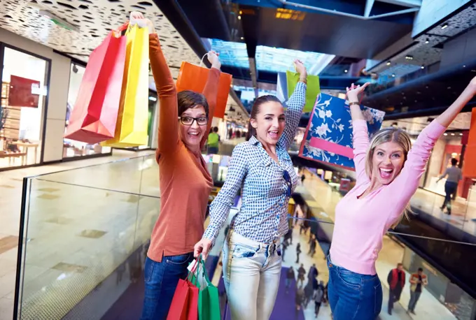 happy young girls in  shopping mall, friends having fun together
