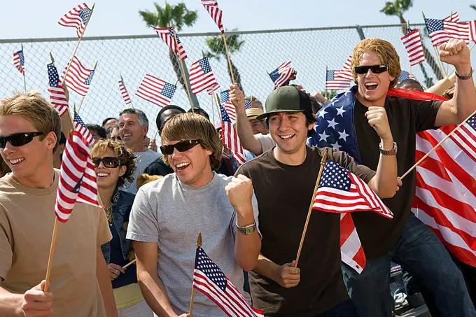 Crowd holding up American flags