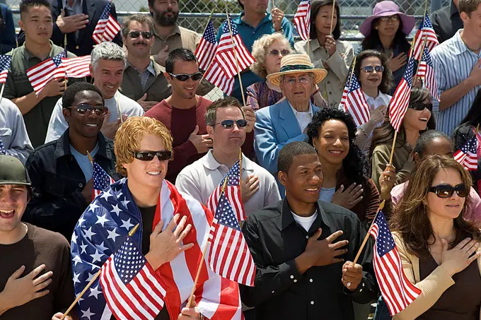 Crowd holding American flags