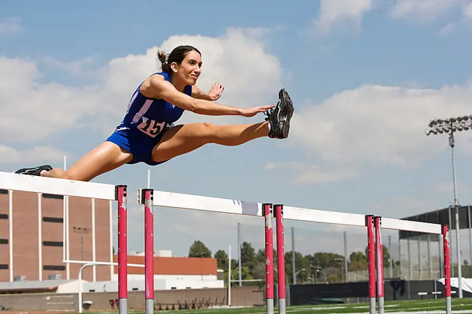 Female athletes hurdling