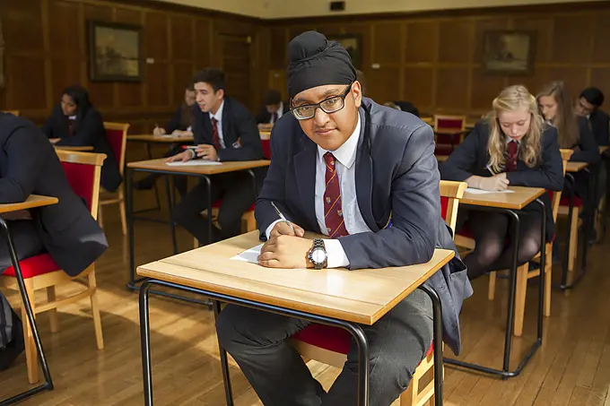 Group of  teenage schoolchildren doing exam