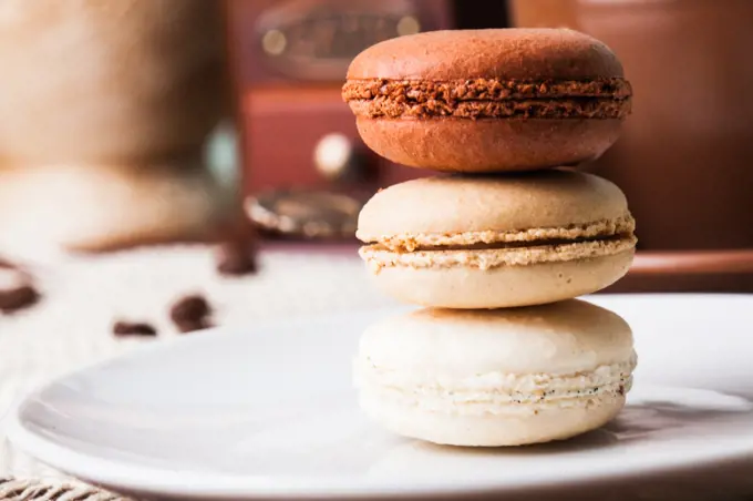 Three colors of macaroons in brown and beige tones