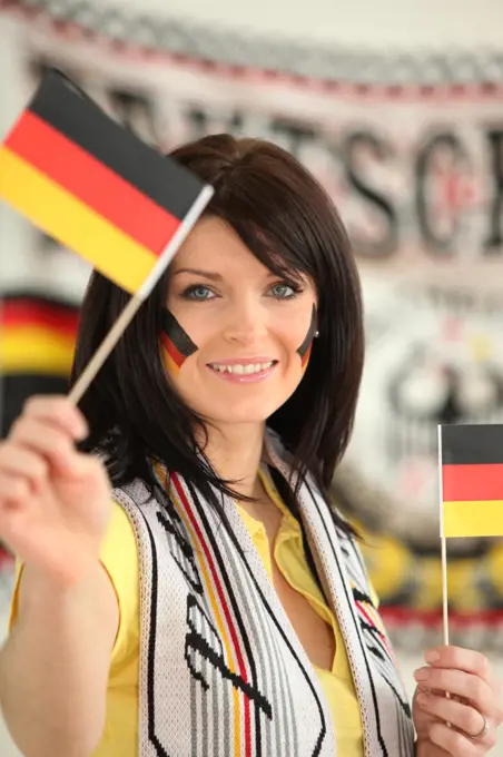 Germany supporter holding miniature flags