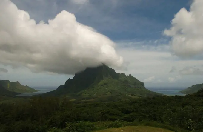 Clouds seeming to touch the top of hills near the ocean, Moorea, Tahiti, French Polynesia, South Pacific