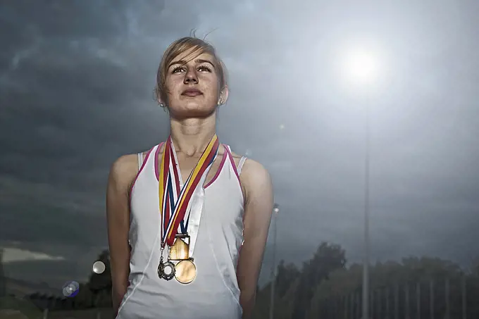 portrait of female athlete with medals