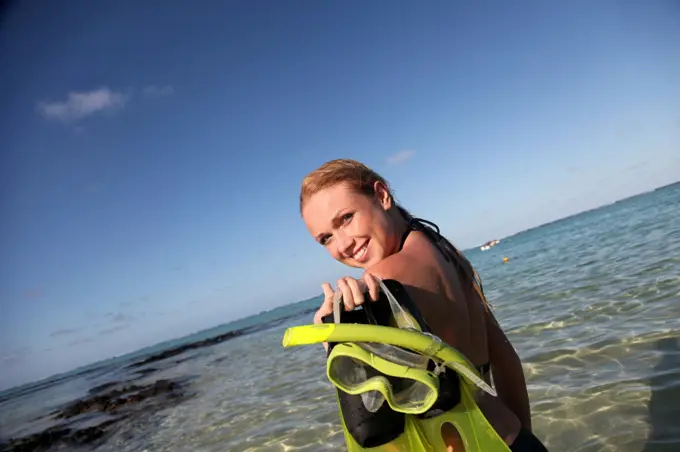 Woman getting out of water after snorkeling journey