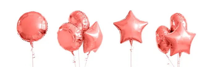 holidays and birthday party decoration concept - many metallic gold helium balloons of different shapes in trendy color of the year 2019 living coral. pink metallic gold helium balloons on white