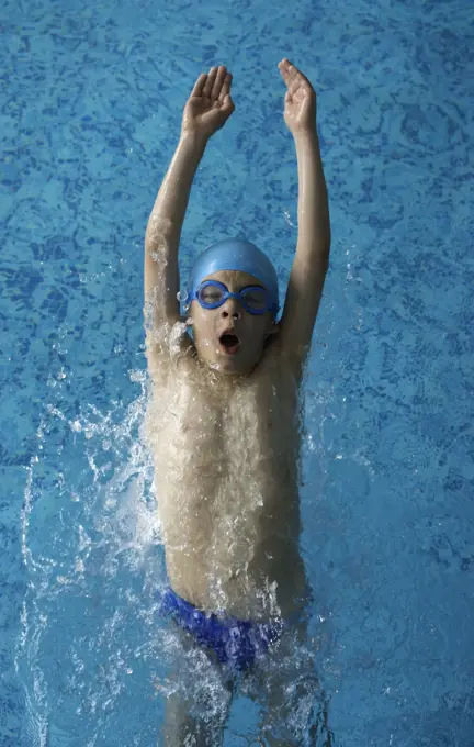 Child swimmer in swimming pool. Blue color swimming pool