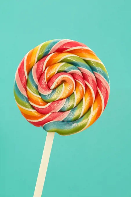 Nice lollipop with many colors in a spiral on a blue background