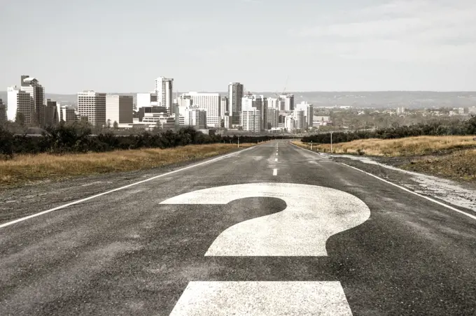 Travel to unknown destination. Cityscape and question mark drawn on asphalt road