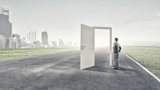 Door to new opportunity. Businessman standing in front of opened doors and making decision