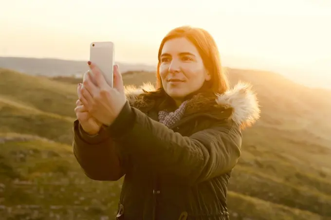 Beautiful woman in outdoor making a selfie