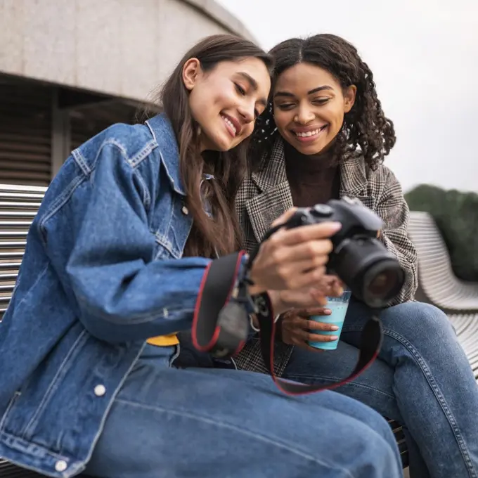 female friends outdoors together with milkshake camera