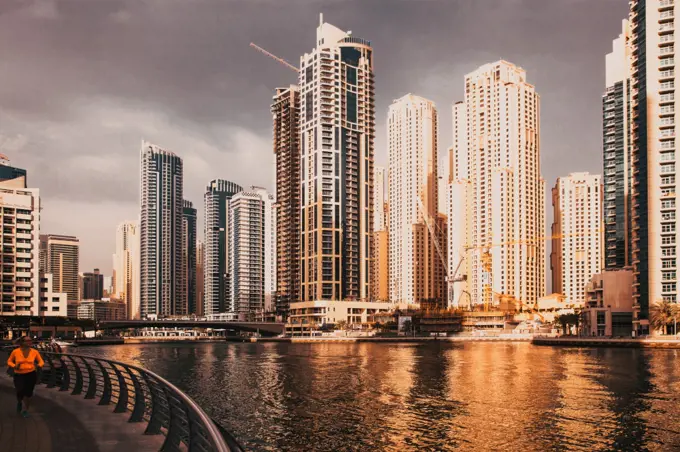 DUBAI, UAE - FEBRUARY 2018: View of modern skyscrapers shining in sunrise lights  in Dubai Marina in Dubai, UAE.