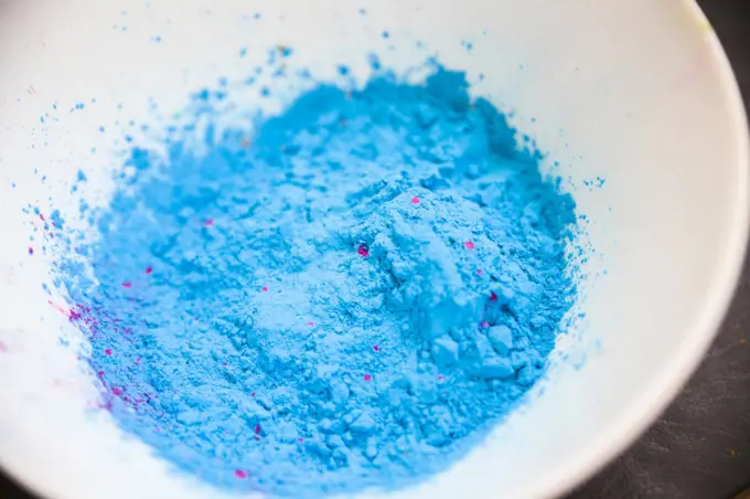 overhead view blue colored powder white bowl