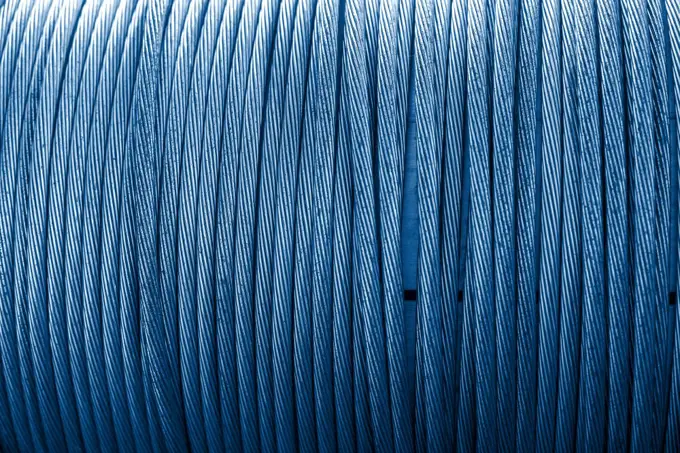 Large spool of electric cable close up. Color of the year 2020 classic blue toned