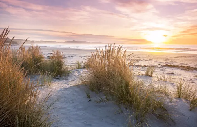 Beautiful Sunset at the Ocean Beach, New Zealand. Inspiring natural and travel background