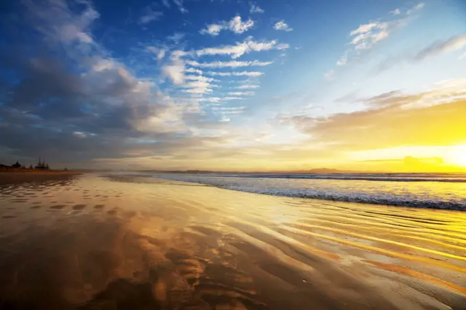 Beautiful Sunset at the Ocean Beach, New Zealand. Inspiring natural and travel background