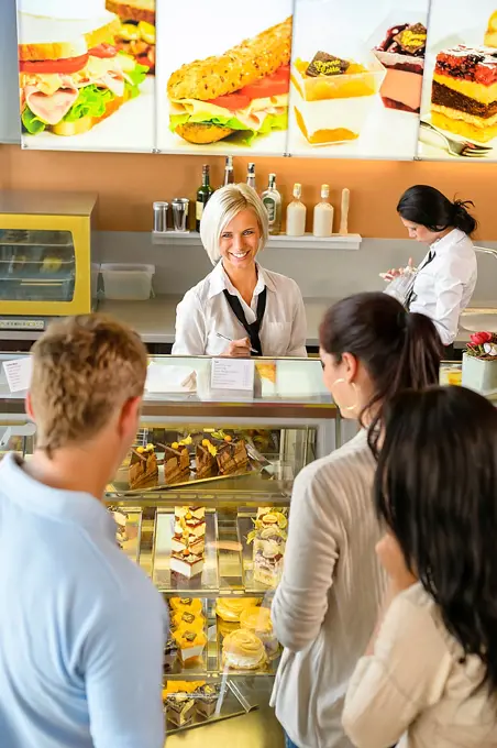 Customers waiting in line to buy dessert woman man cafe