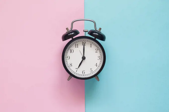 Close up clock on pink and blue background, Pastel colors concep. Close up clock on pink and blue background, Pastel colors concept